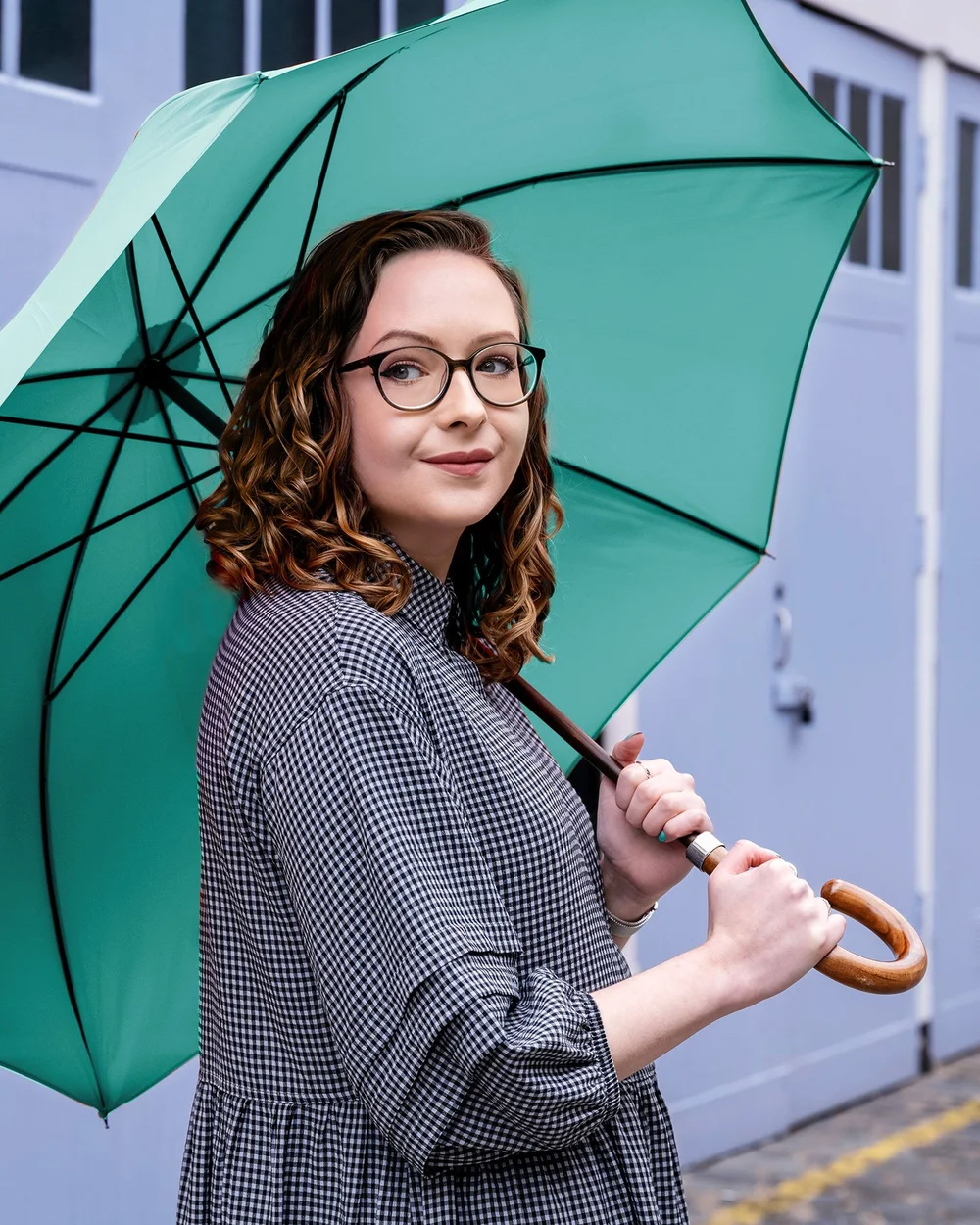Charlotte Stapleton holding a green umbrella